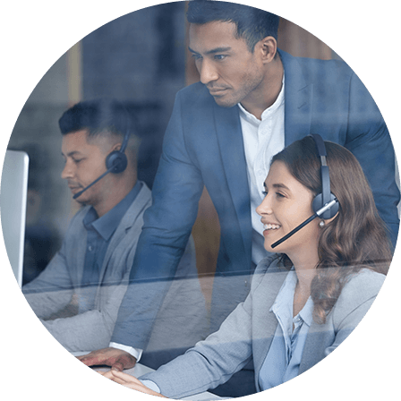 A team of professionals wearing headsets, working collaboratively in an office, symbolizing customer support or technical assistance.