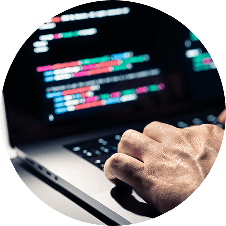 A close-up of a person typing code on a laptop, symbolizing programming or software development.