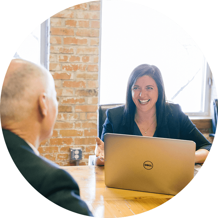 Colleague talking and smiling to each other in a conference room.